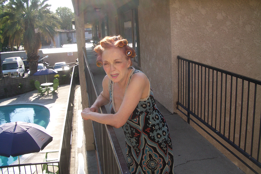 Iris Karina as Apartment Manager in the music video 'EBT California' directed by Kevin Johnson
